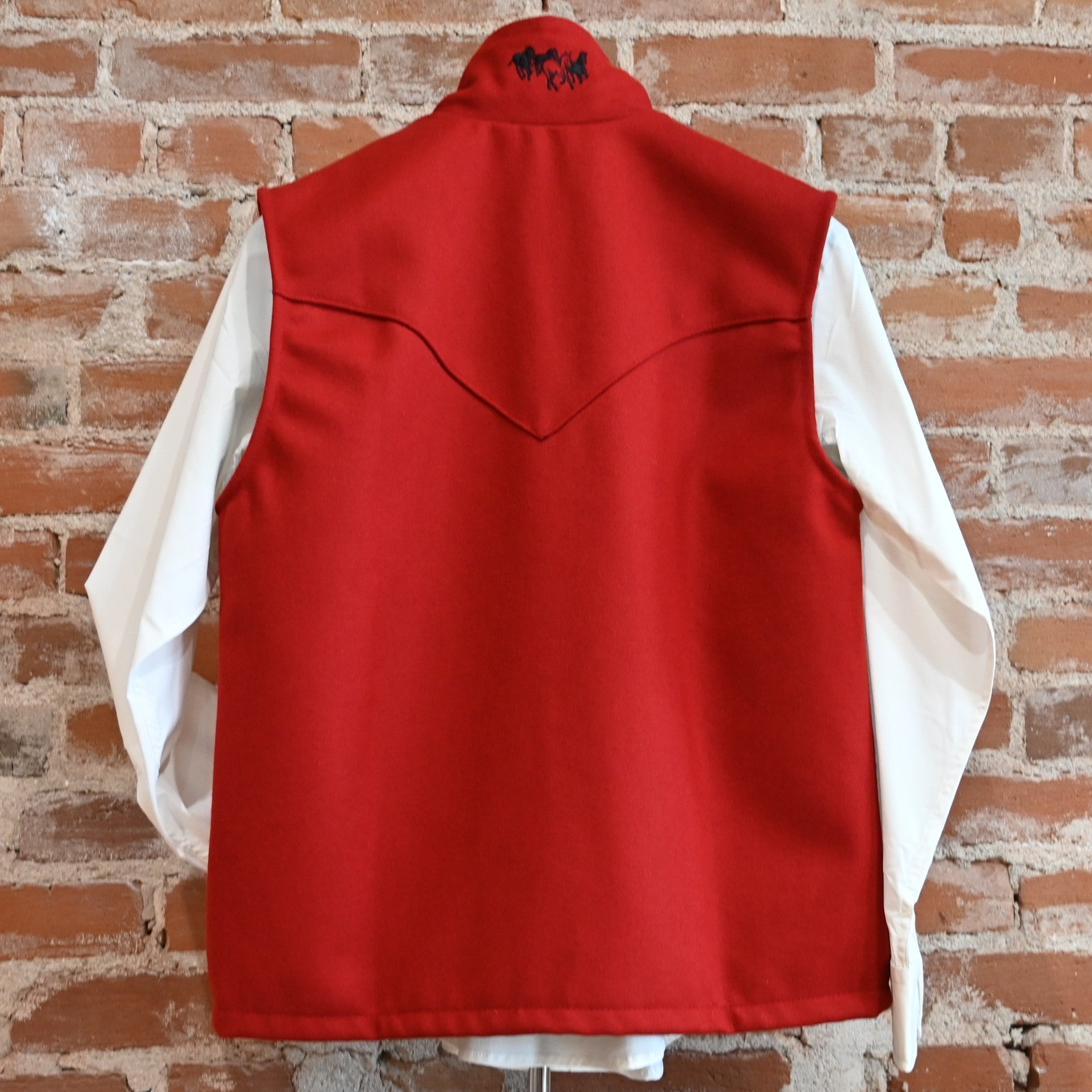 View of Schaefer ladies wool Arena vest in black or red with Western yokes and storm-flap zip front