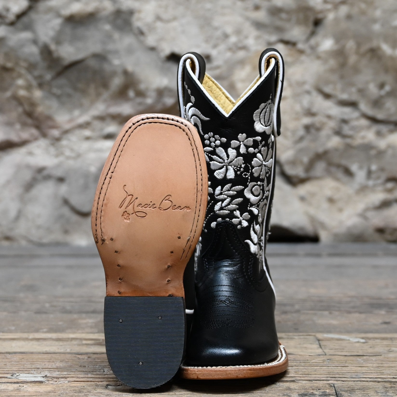 View of Macie Bean Kids Black Eyed Susan boot with black leather and white floral stitching