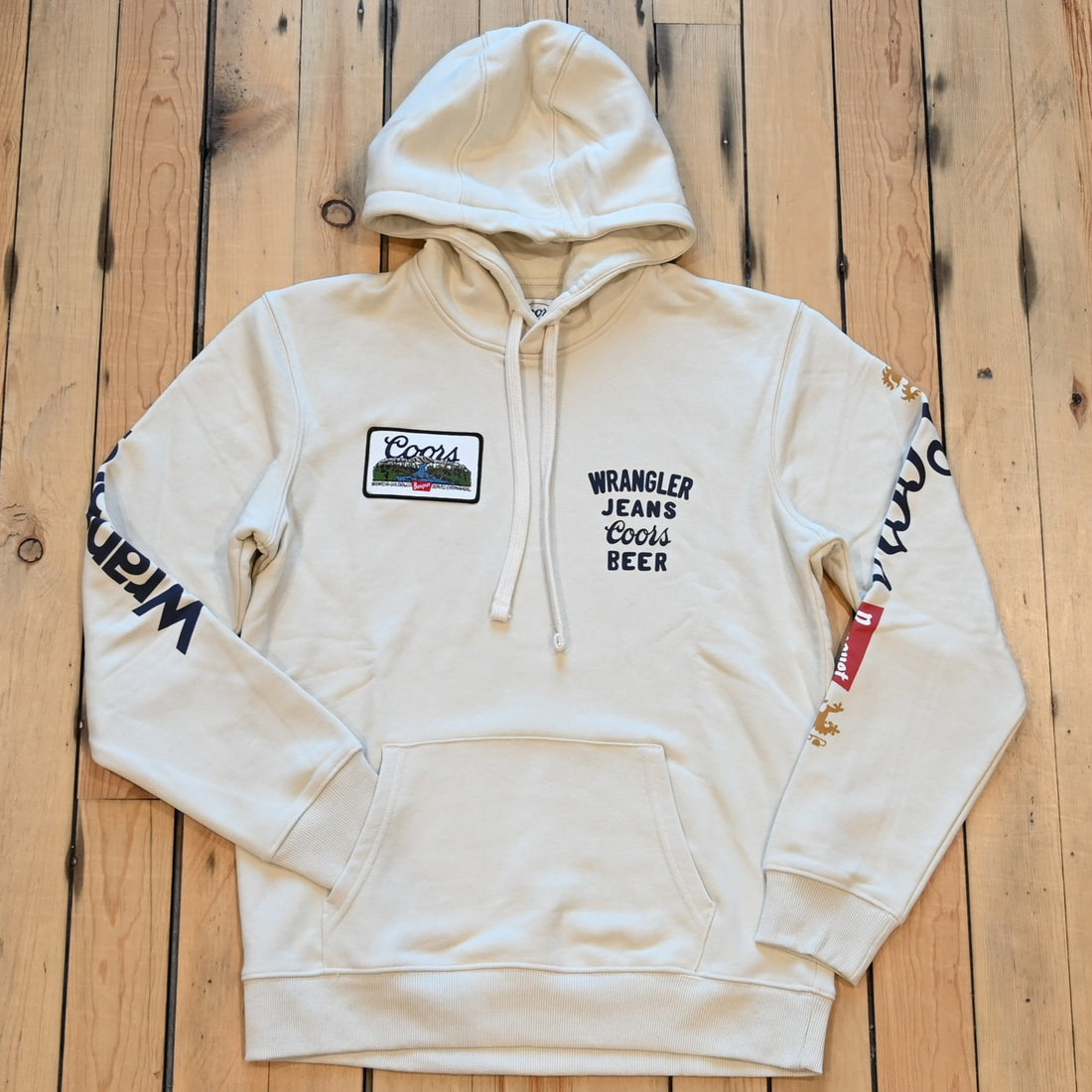 Wrangler × Coors graphic hoodie in antique white with logos down sleeves