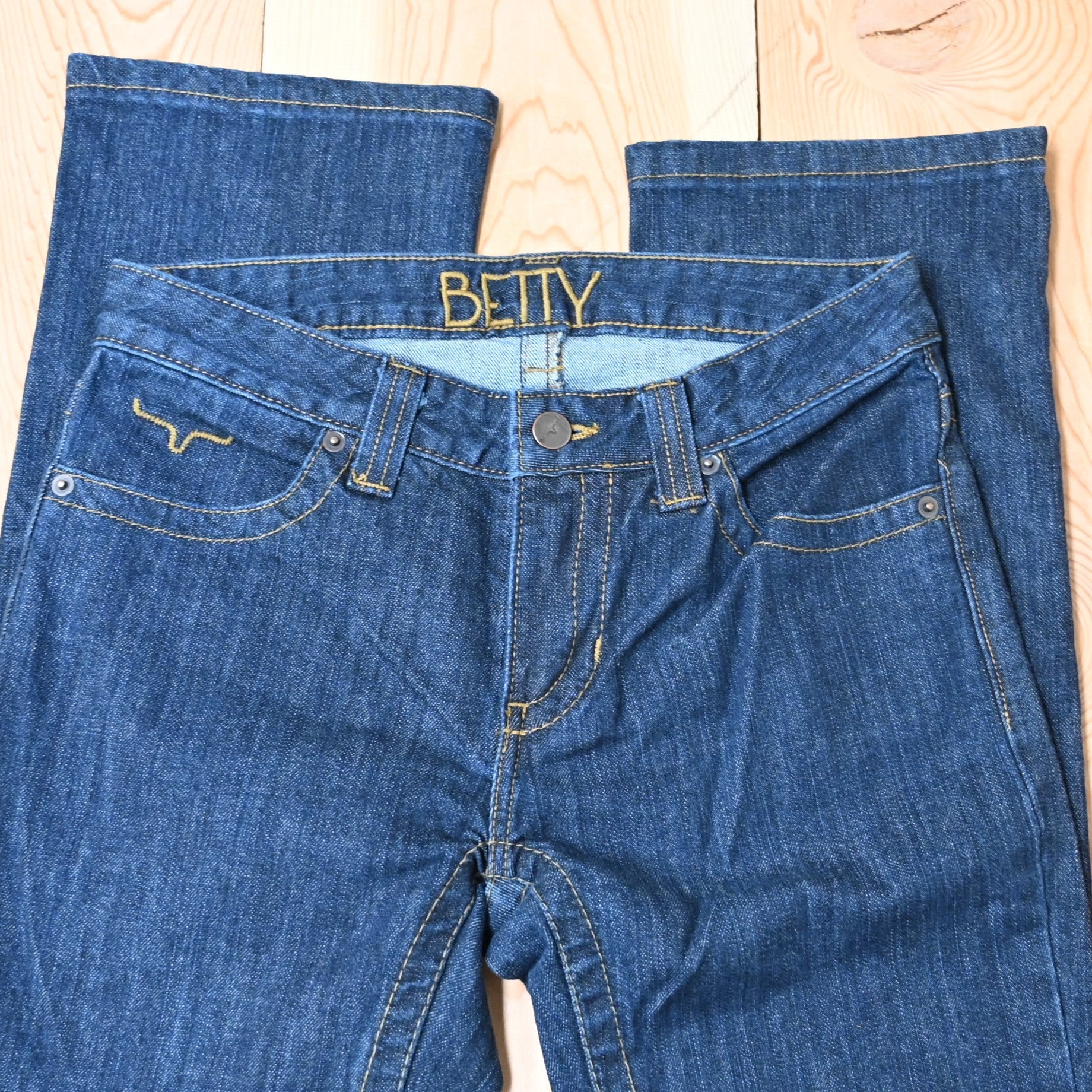 View of Kimes Ranch Betty Jeans in Blue, featuring embroidered horns on back pockets and a modest bootcut leg