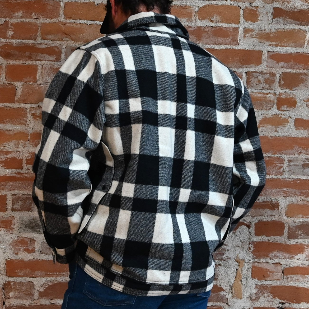 View of Filson Mackinaw Cruiser in Navy, Charcoal & Natural/Black Heritage Plaid featuring button-secure front closure, adjustable cuffs, and multiple pockets