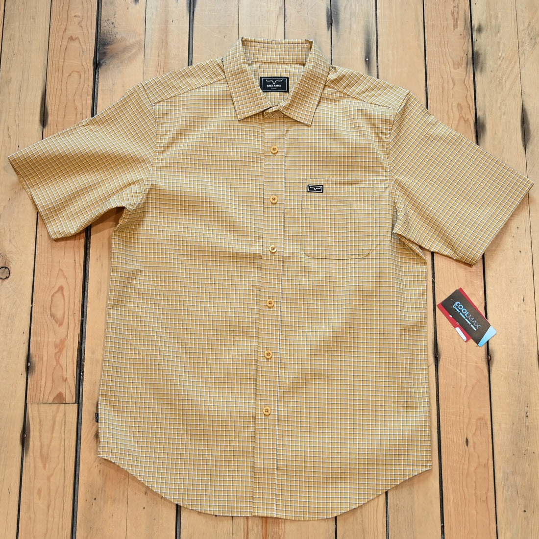 View of Kimes Ranch MC Cooper Short Sleeve Button-Up Shirt in Gold, featuring a grid plaid pattern and snap button front