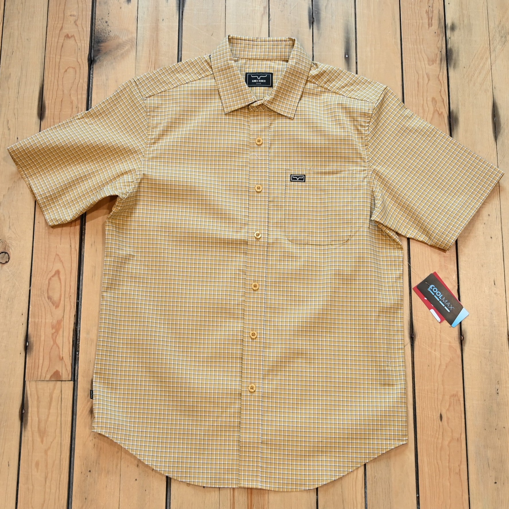 View of Kimes Ranch MC Cooper Short Sleeve Button-Up Shirt in Gold, featuring a grid plaid pattern and snap button front