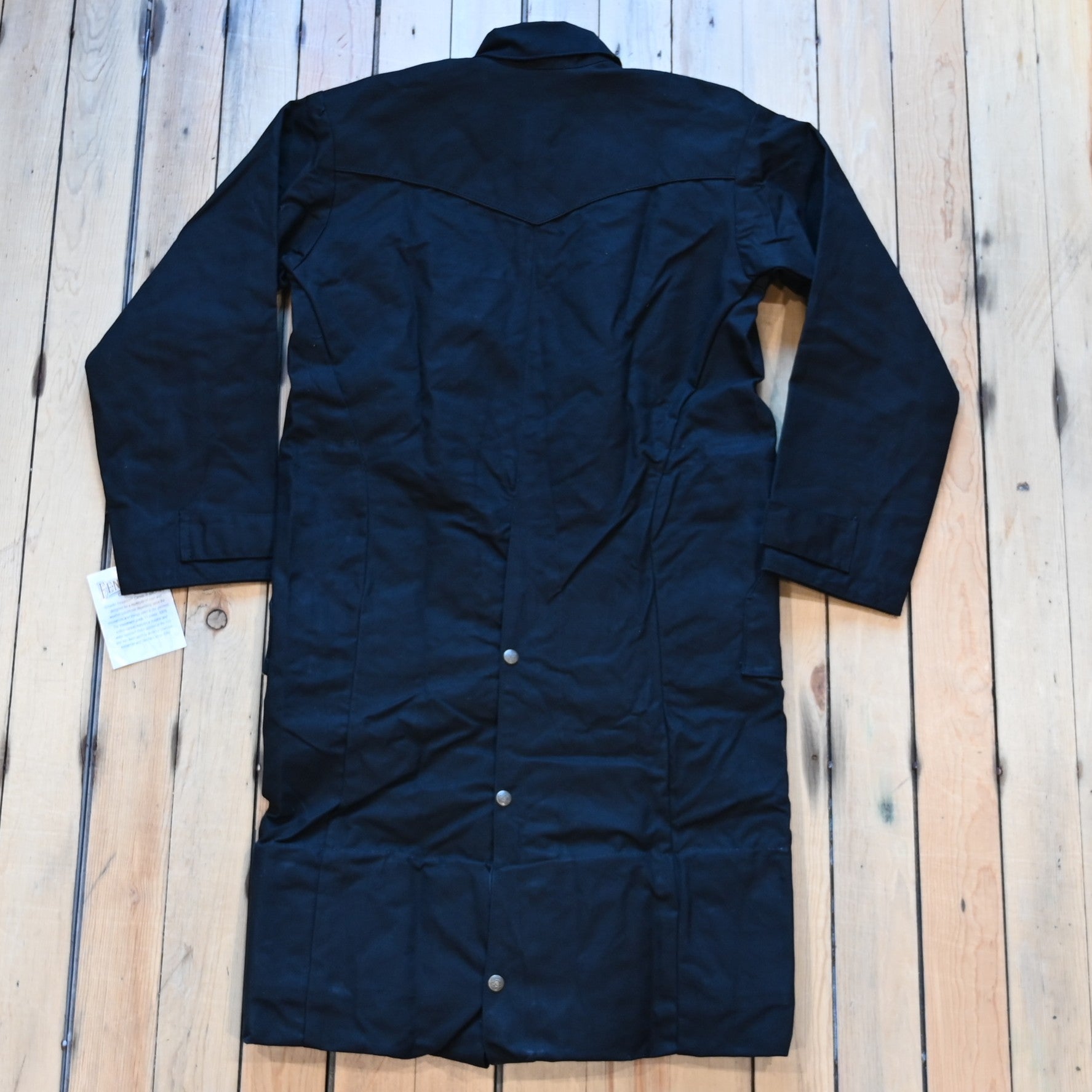 View of Black full-length Schaefer canvas duster coat with utility pockets and corduroy collar