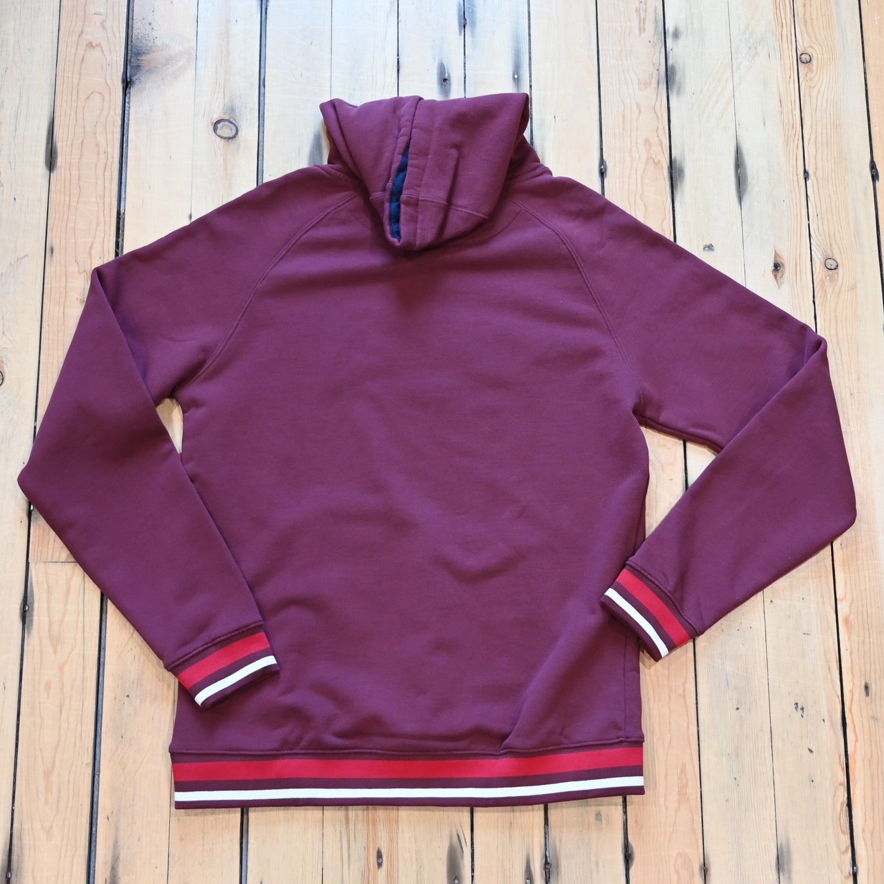 View of Kimes Ranch Kubo Sweatshirt in Burgundy, featuring a vibrant striped bottom and embroidered logo