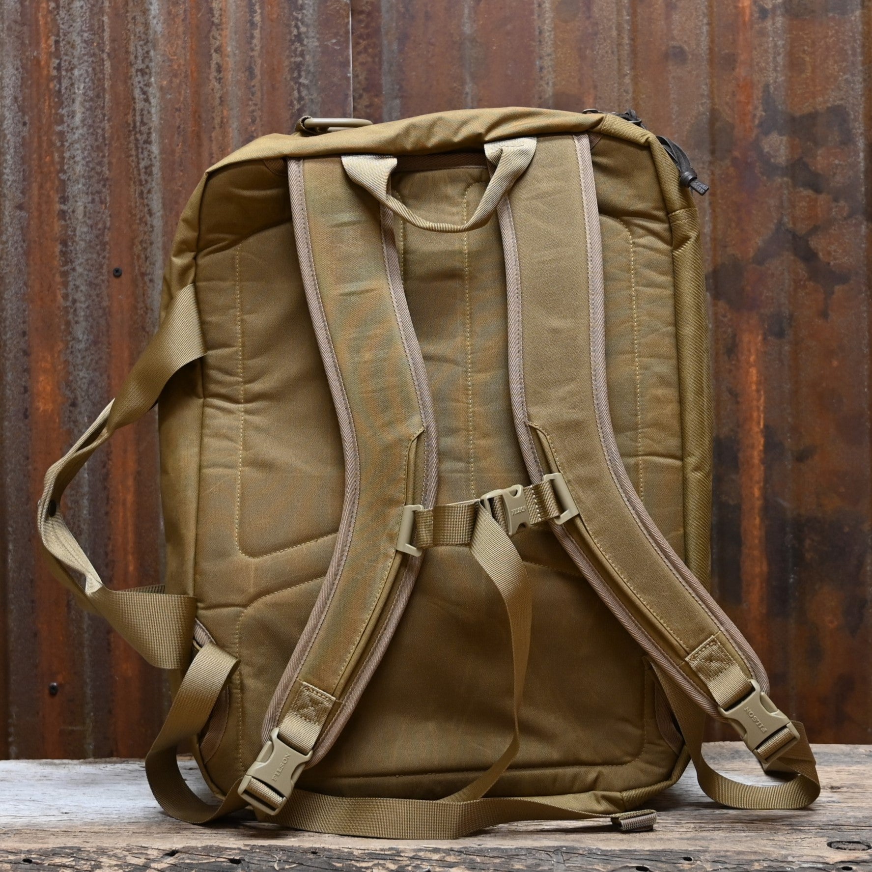 View of Filson Surveyor Pullman Pack in Dark Tan/Flame, showcasing durable Cordura® nylon construction and versatile carry options