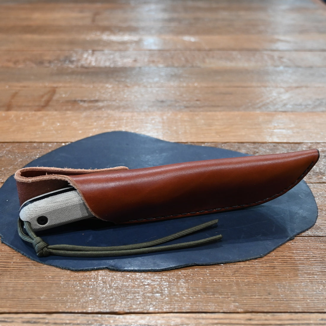 ESEE 4P knife with modified ergonomic handle and black leather sheath, 2025 edition