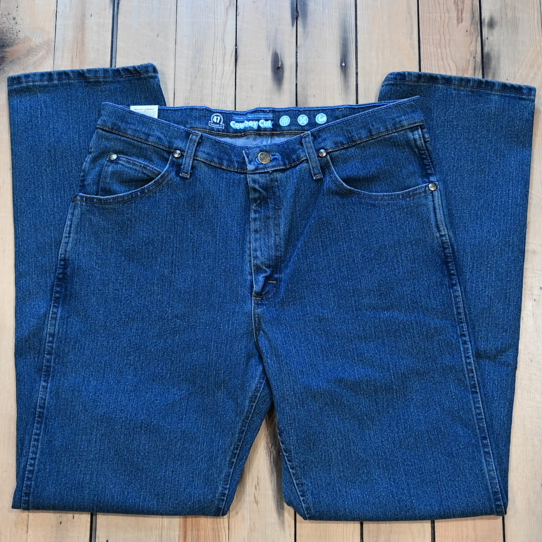 View of Wrangler Men’s Premium Cowboy Cut jeans in Vintage Stone with stretch denim and moisture-wicking comfort