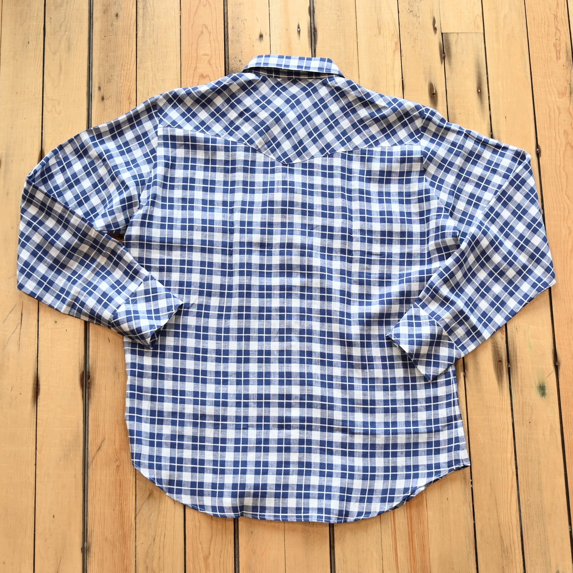 View of Blue Blanket men’s blue plaid linen Western shirt with pearl snaps and yoke detail