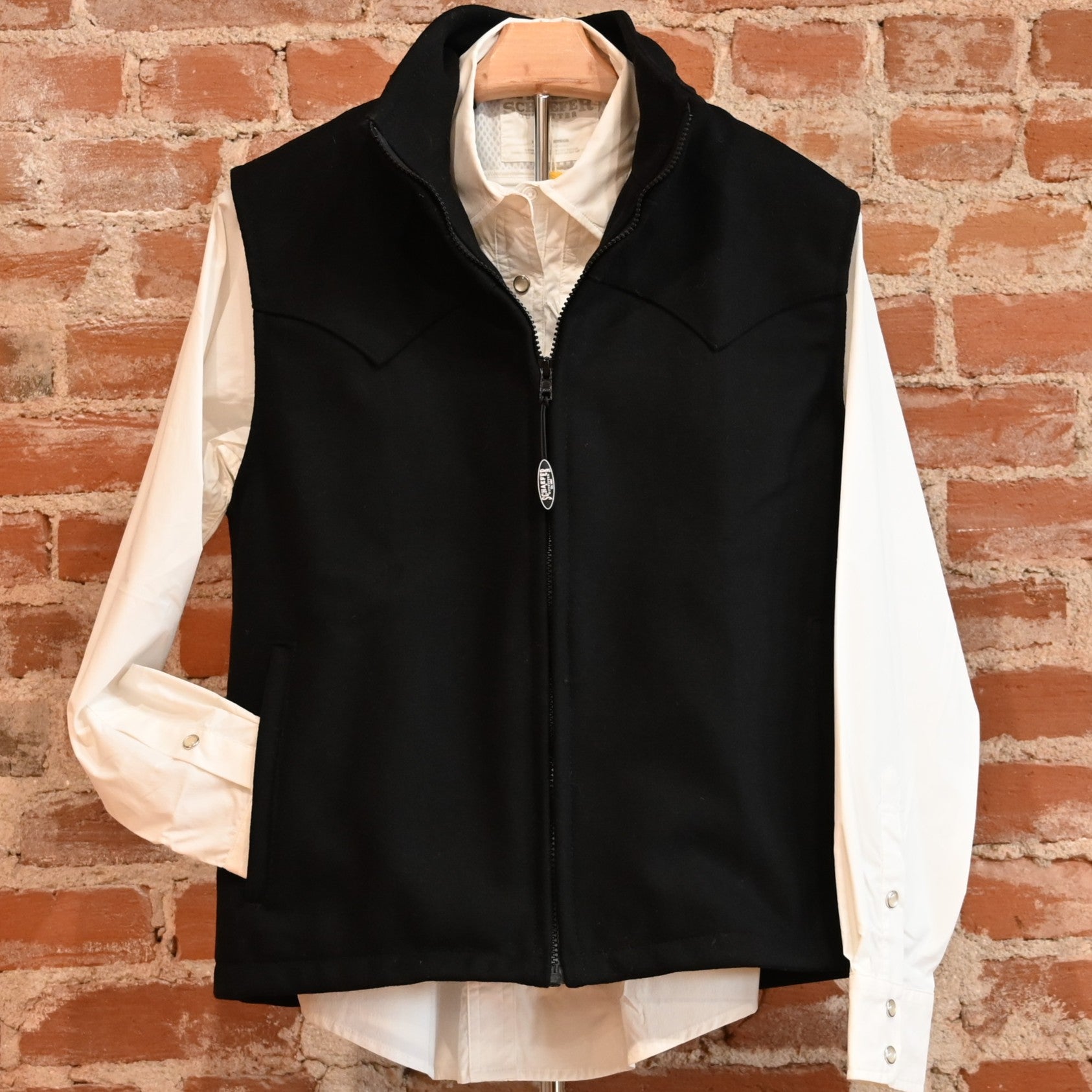 View of Schaefer ladies wool Arena vest in black or red with Western yokes and storm-flap zip front