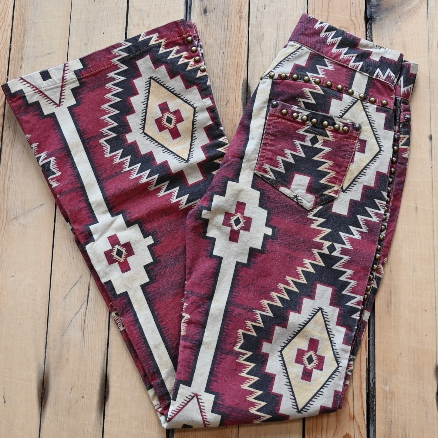 View of Double D Ranch Left Behind Pants – Traditional rug pattern with brass accents for a Western-inspired design