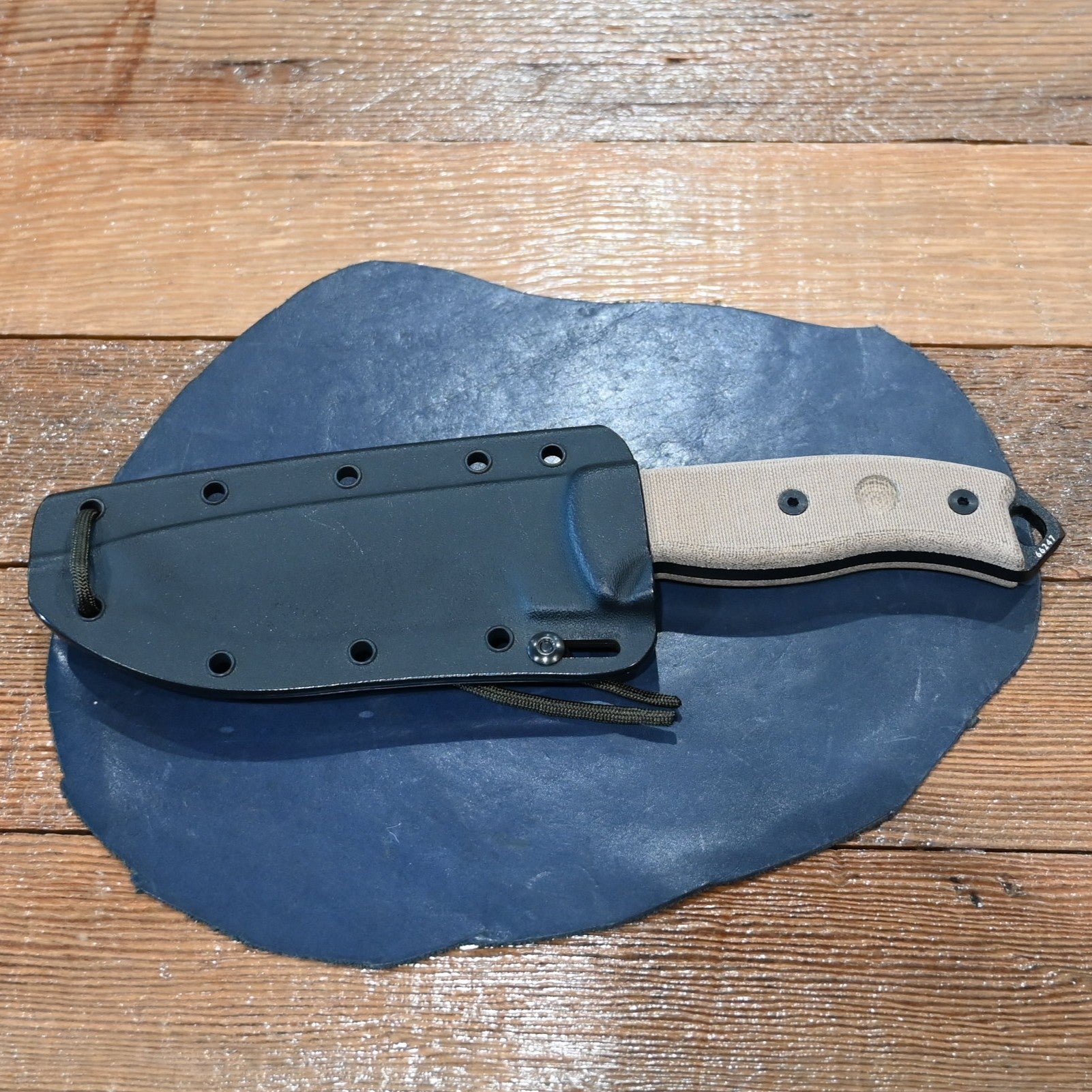 ESEE-5 serrated edge fixed blade knife with black coated blade, micarta handle, and MOLLE sheath