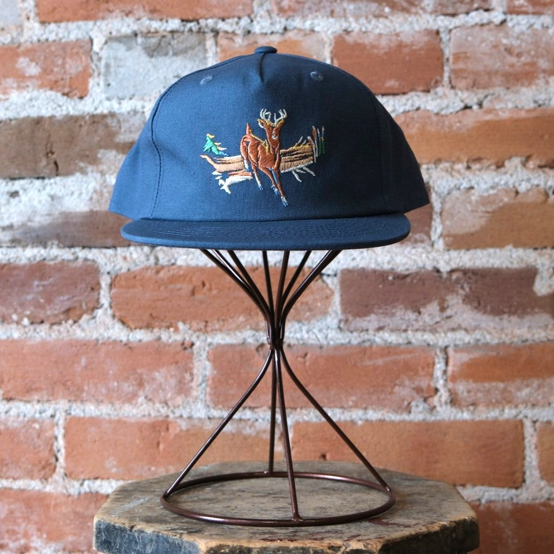 Filson Deer Trucker Cap in Dusty Blue featuring a 5-panel pinched front and custom deer embroidery.