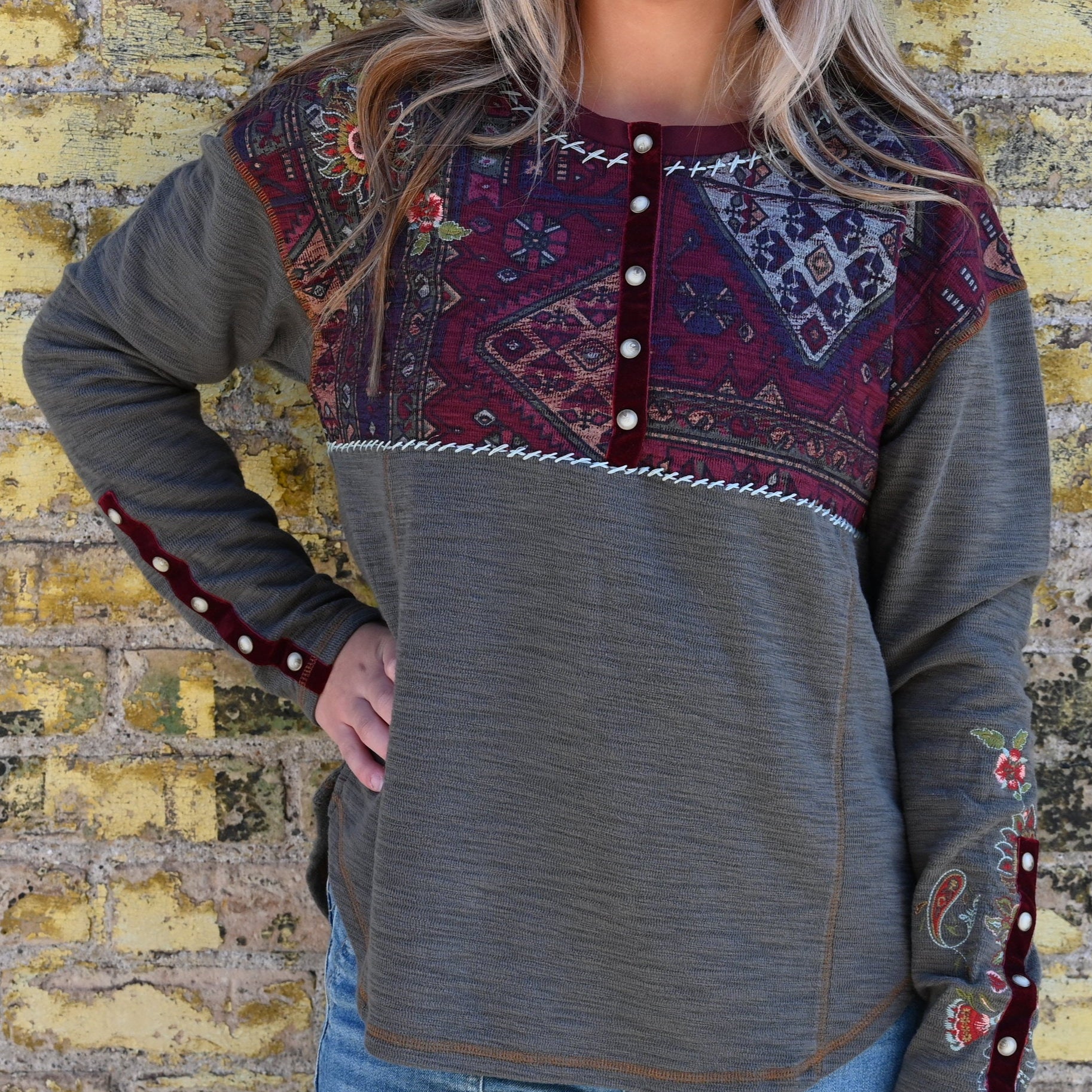 View of Double D Ranch Carpet Bagger Long Sleeve Tee – Patina-colored tee with a colorful yoke, pearl snap front, and intricate embroidery for a Western-inspired design