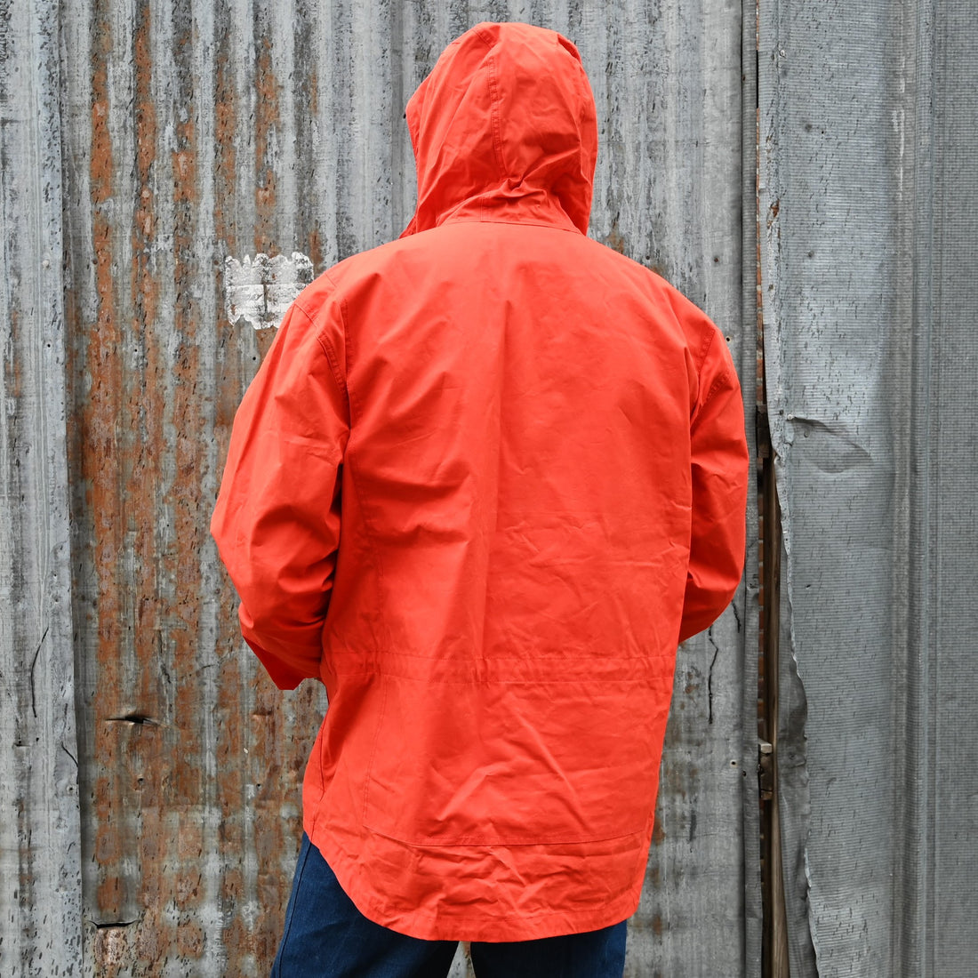 View of Filson Ranger Anorak Pullover – EX Orange, showcasing adjustable features and multiple pockets for outdoor utility