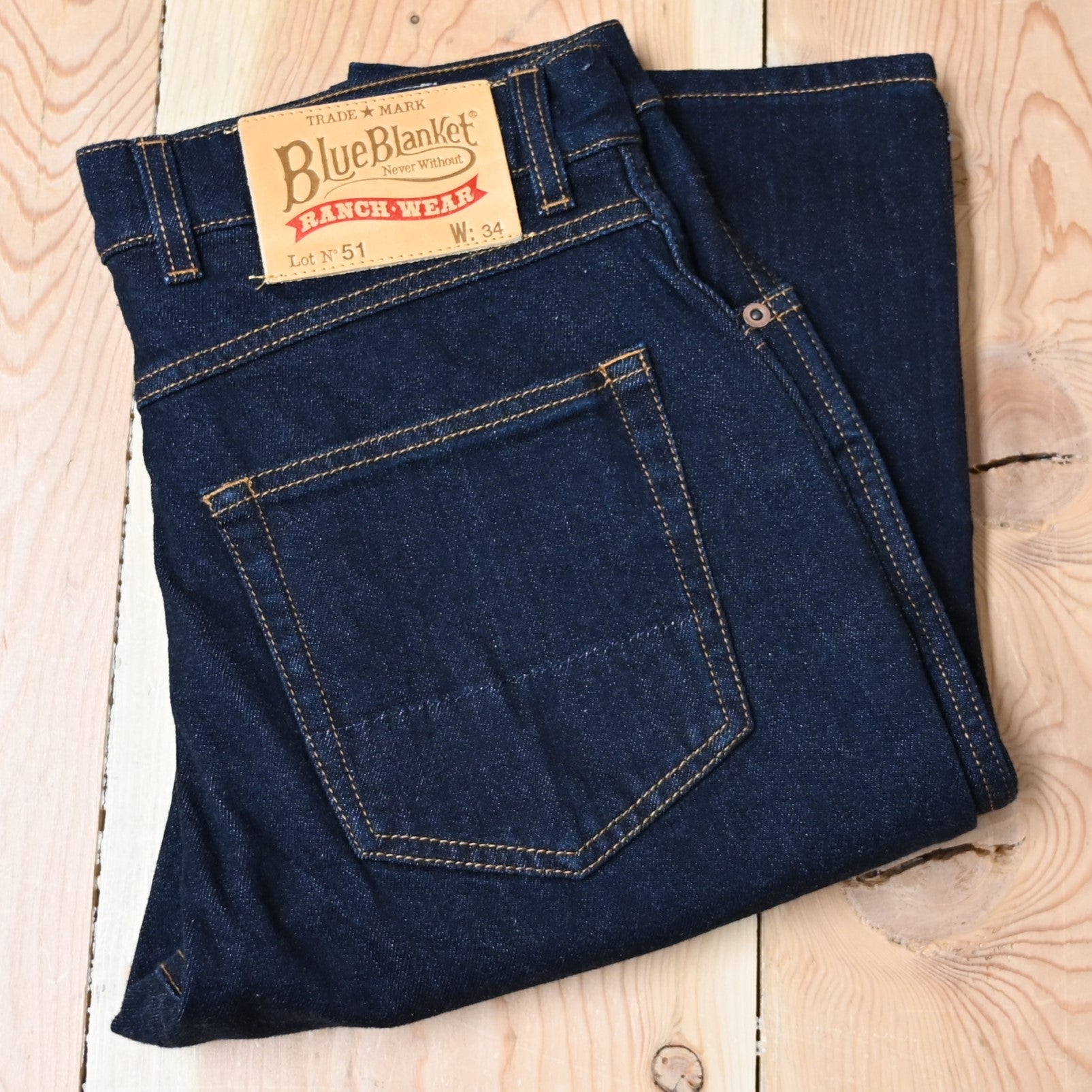 View of Blue Blanket men’s dark indigo denim jeans with straight-leg fit and leather patch