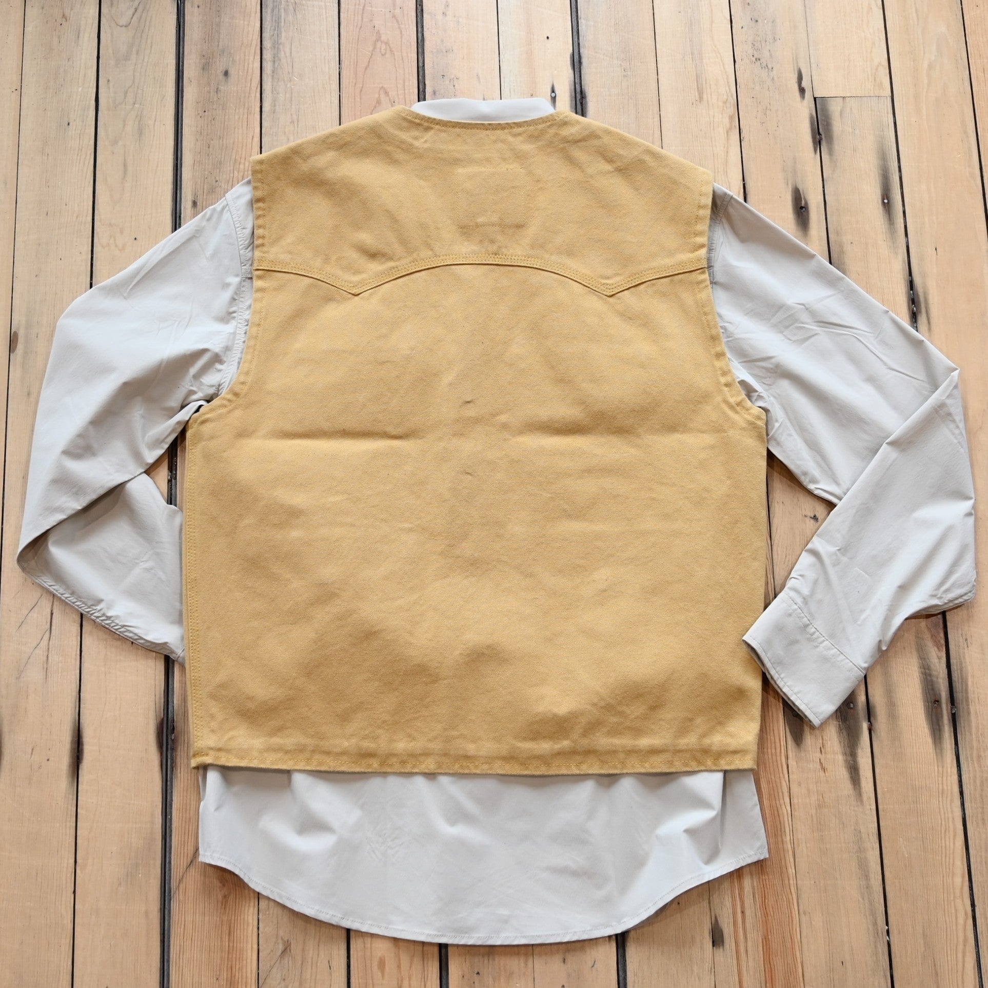 View of Schaefer brushcloth vest in suntan canvas with utility pockets and brass buttons