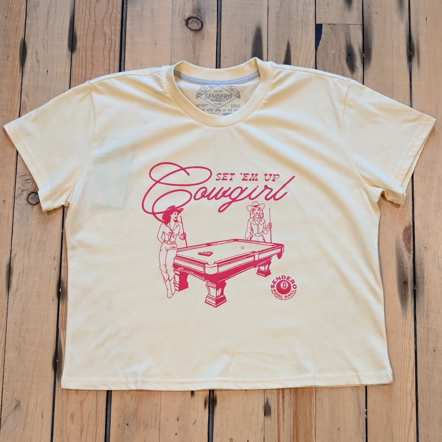 Ladies cream boxy tee by Sendero with two cowgirls playing pool and “Set ’Em Up Cowgirl” text