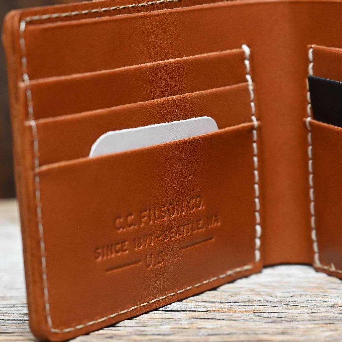 View of Filson Leather Bi-Fold Wallet in Tan featuring six card slots and a cash compartment