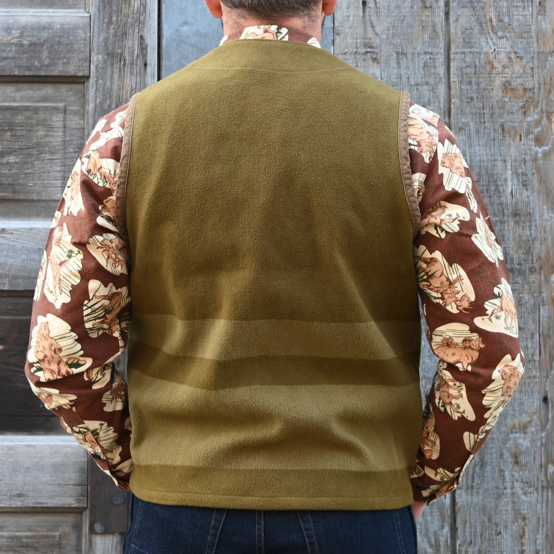 View of Filson Beartooth Cruiser Vest in Marsh Olive Blanket Stripe featuring snap-close front and reinforced pockets