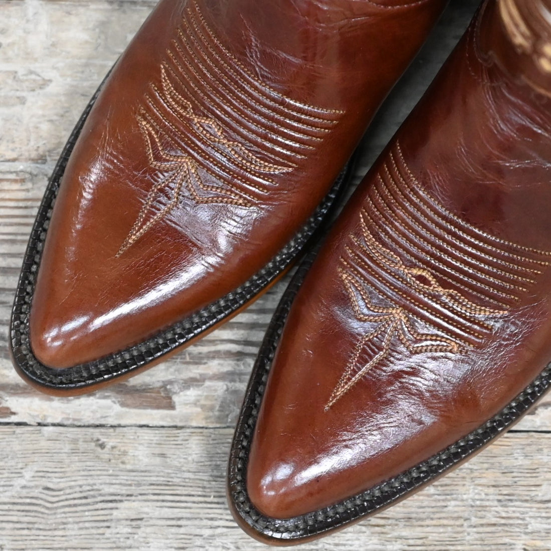 View of Lucchese ladies 12″ whiskey leather boot with butterfly inlay and sharp rounded toe