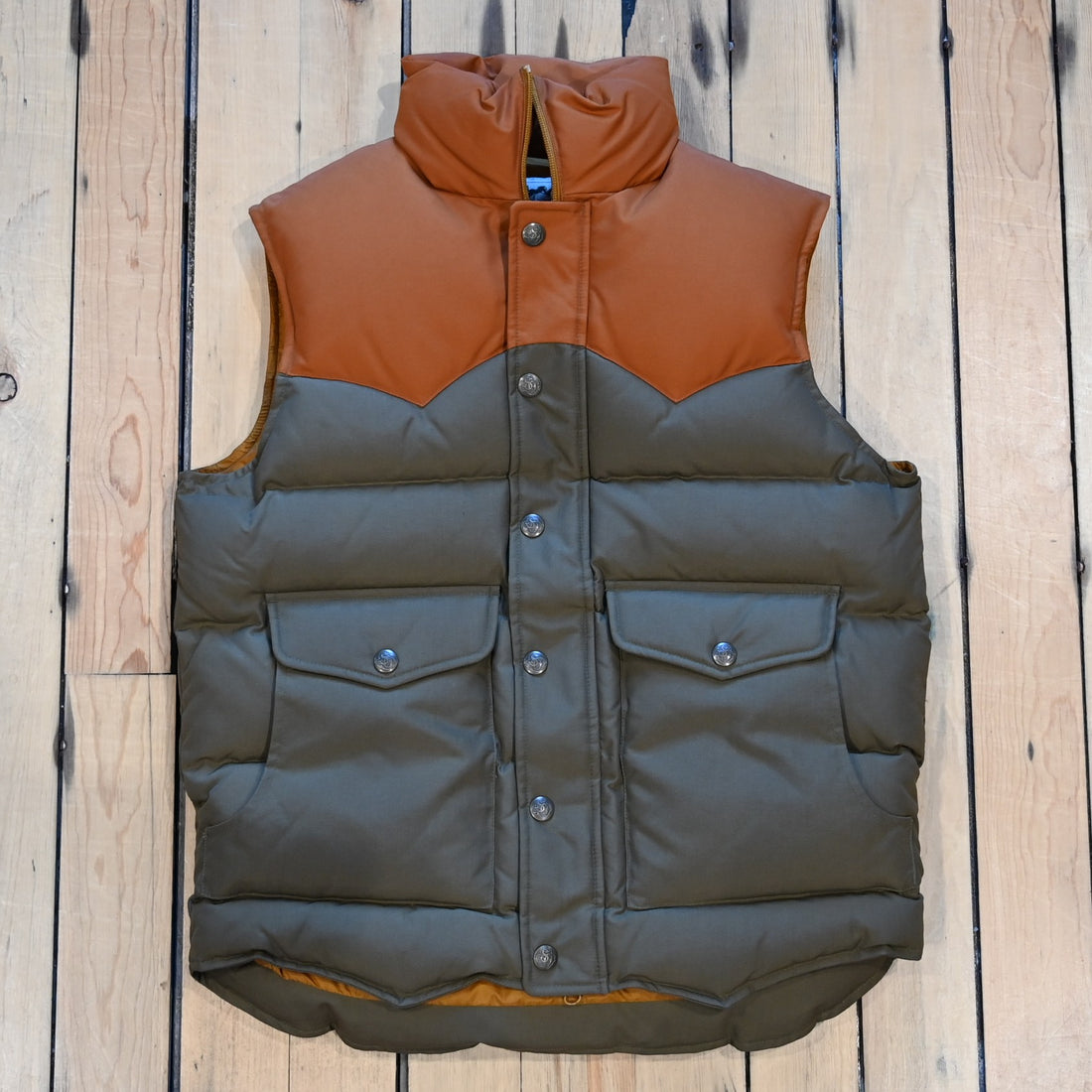 Schaefer Bozeman Down Vest in cedar color with nylon shell, insulated down fill, and storm flap zipper