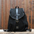 View of Filson Rugged Twill Drawstring Backpack in Black featuring leather straps and a rain flap