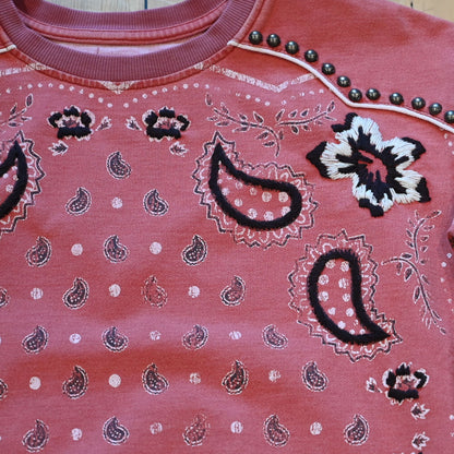 View of Ladies bandana sweatshirt in muted mahogany with embroidered and studded bandana print