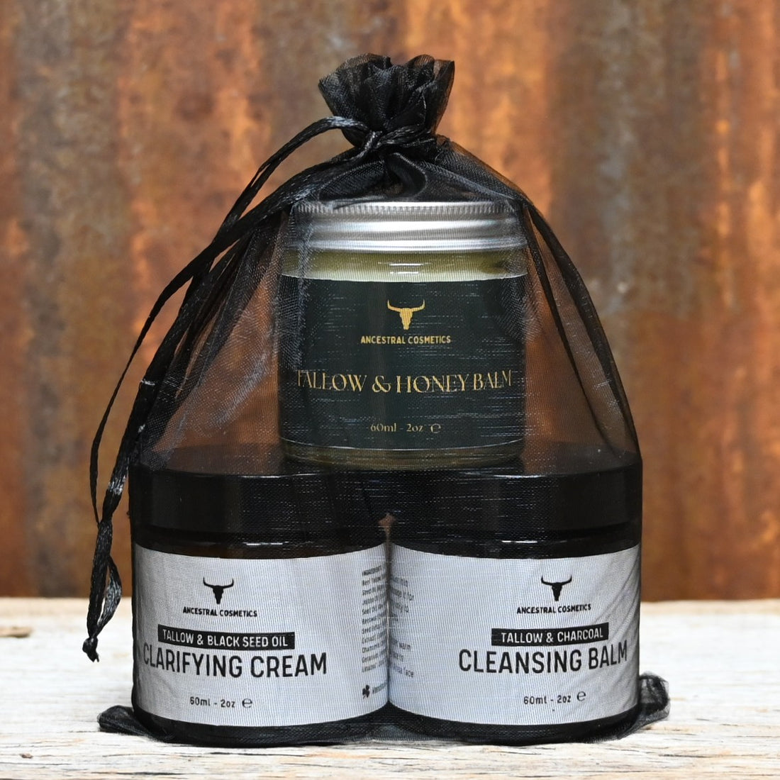 Ancestral Cosmetics skincare set with clarifying cream, charcoal cleansing balm, and tallow honey balm