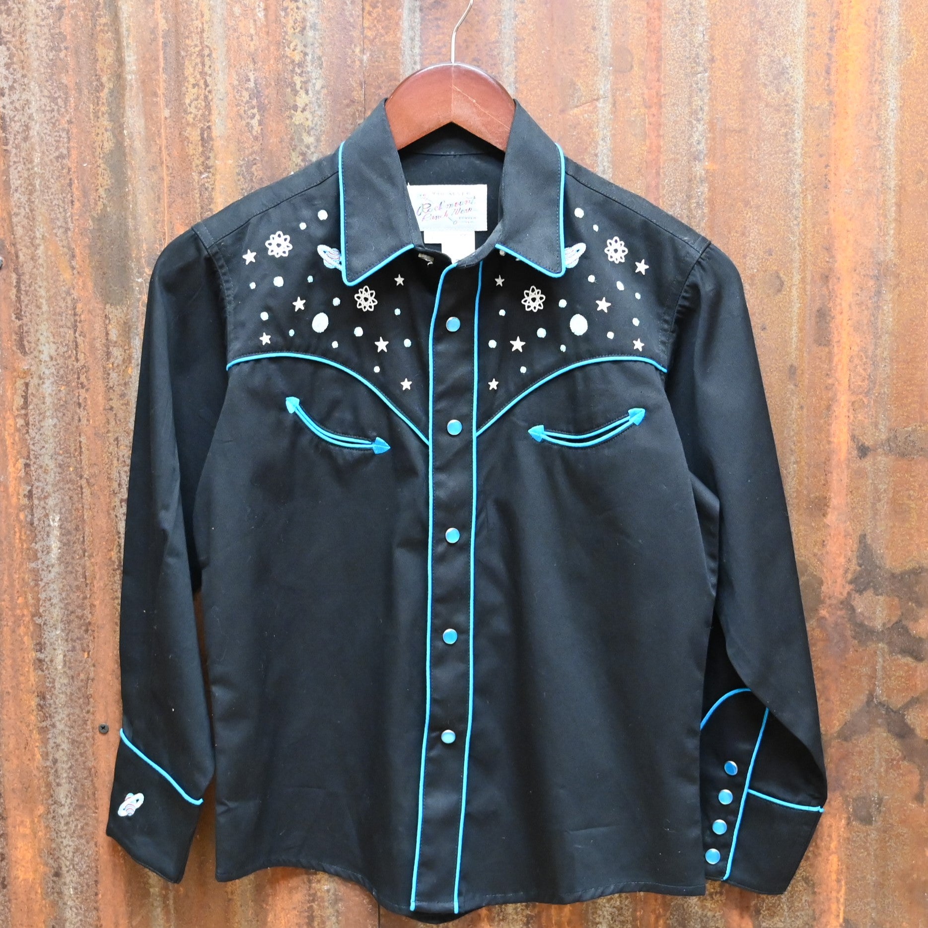 View of Black Rockmount kids western shirt size Large with embroidered stars, planets, and rockets