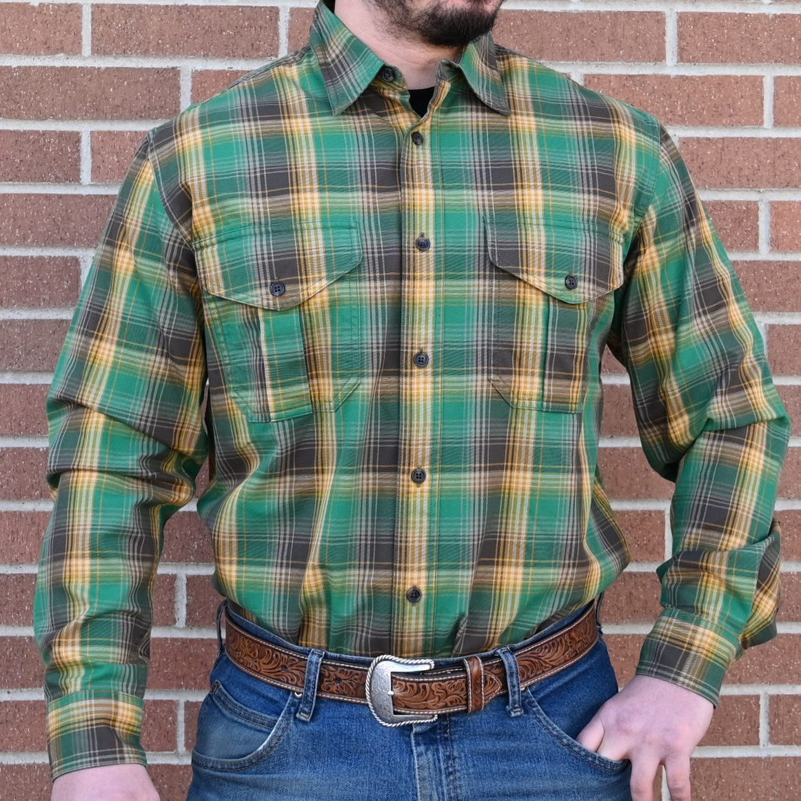 View of Filson Lightweight Alaskan Guide Shirt in Yellow/Green/Gray Plaid featuring gusseted chest pockets and relaxed fit