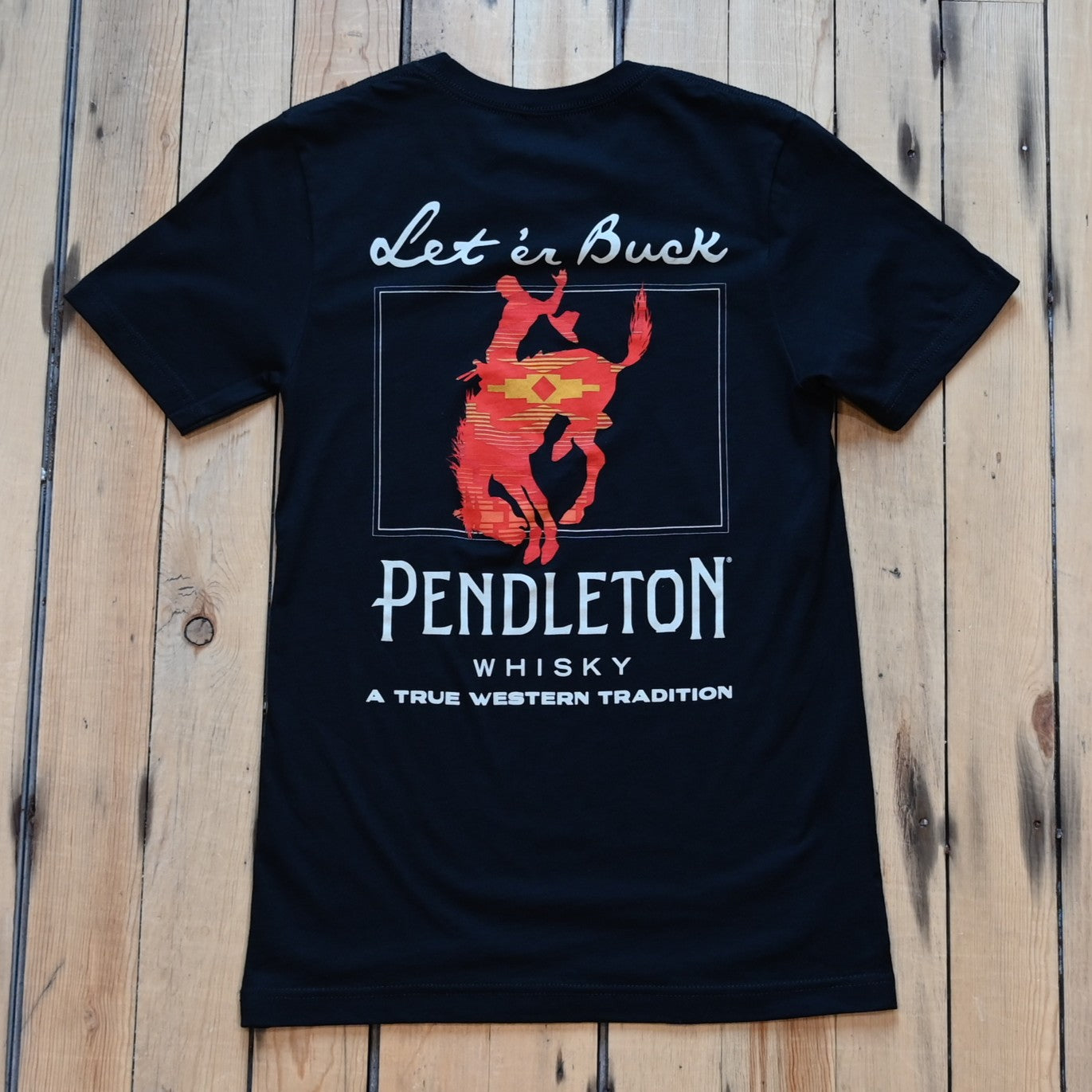 Pendleton black Let’er Buck Whisky T-Shirt with red bucking horse front graphic and Pendleton bucking horse back design