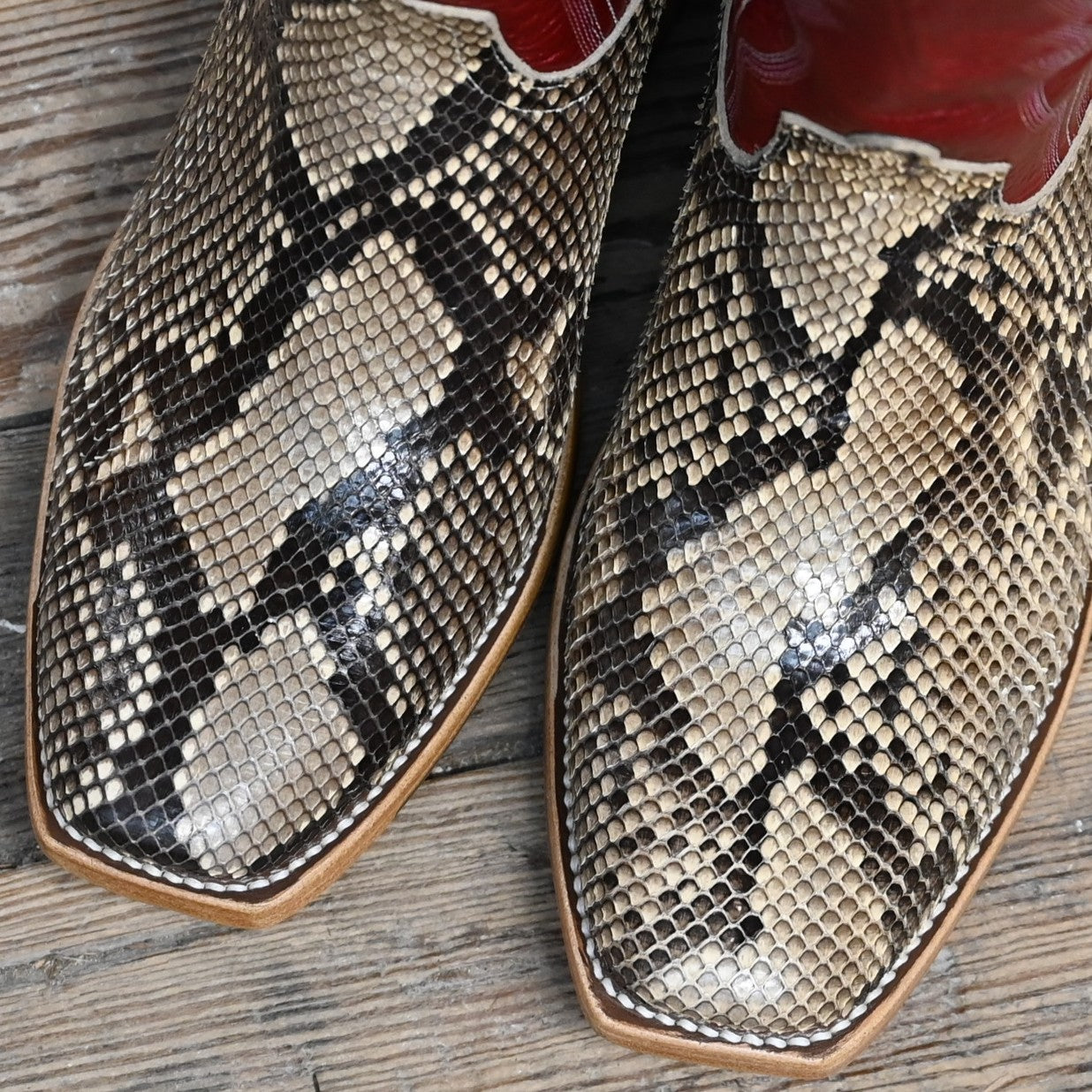 View of Macie Bean 13″ boot with red Station shaft, mink python vamp, and cutter toe