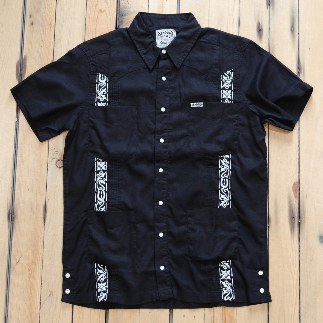 Sendero Caballero Guayabera in Black showing the intricate tonal embroidery and four-pocket design.