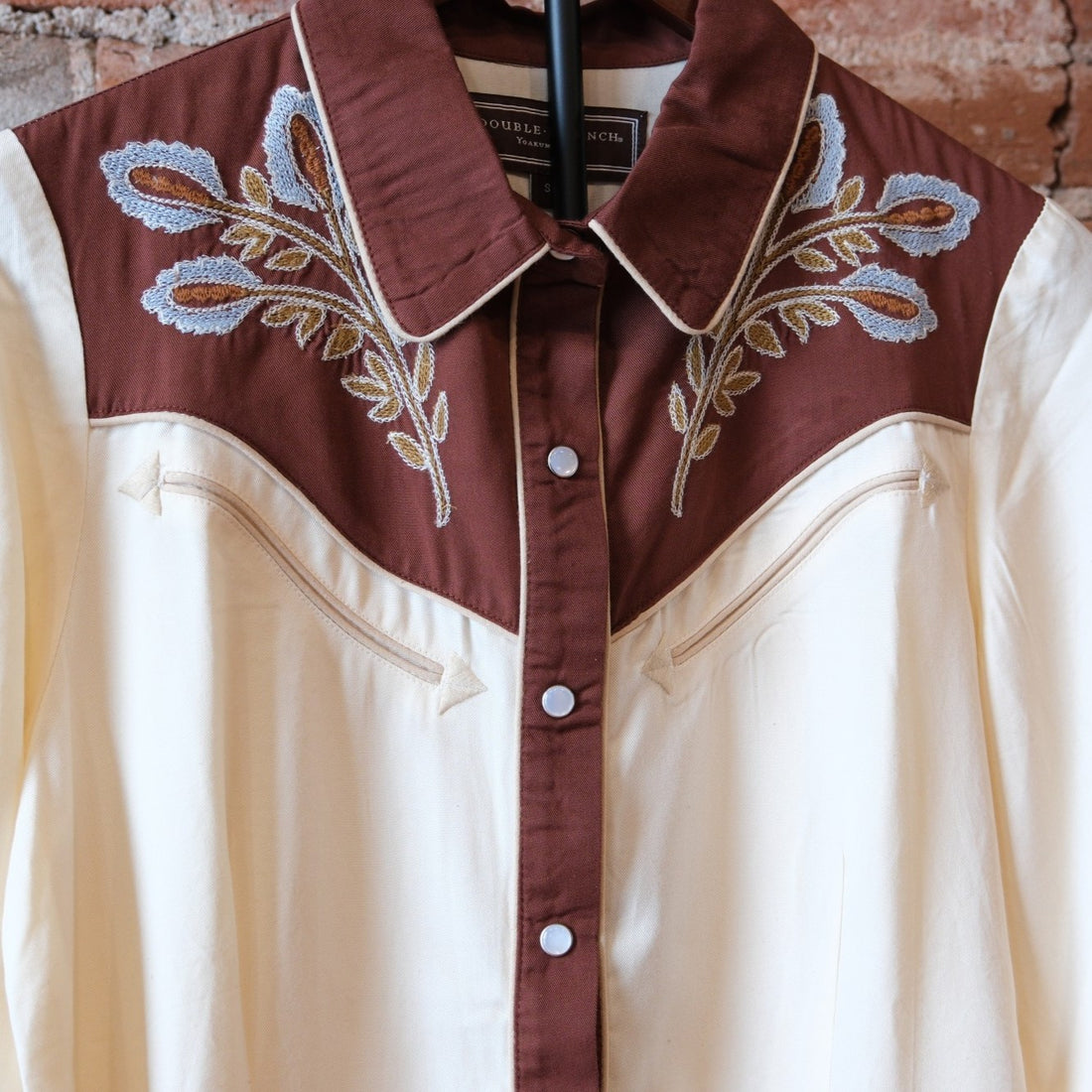 Double D Ranch Wild Bluebonnet Rodeo Top in Bone showing the pearl snap front and bluebonnet embroidery.