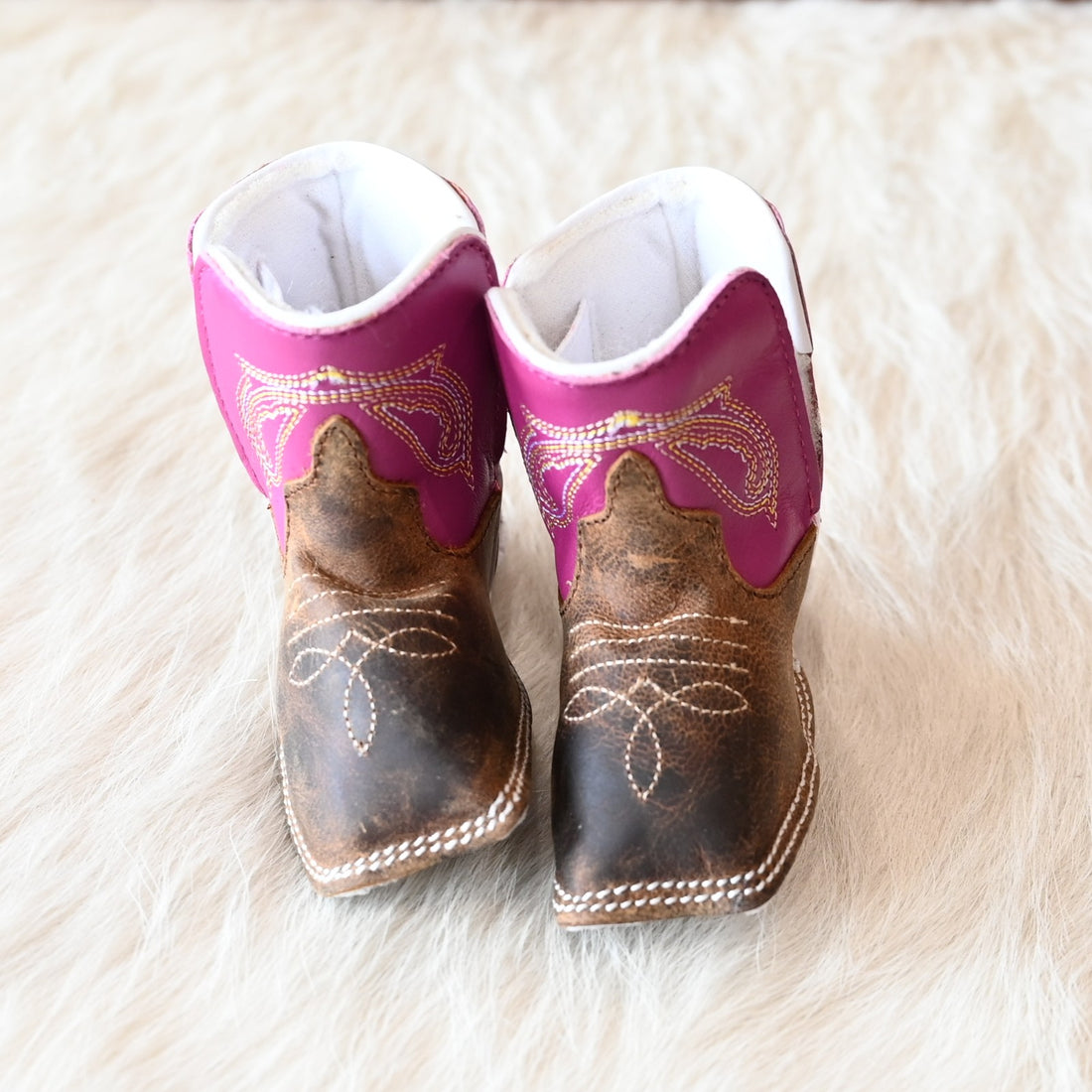 View of Anderson Bean Baby Bean boot with bone antique goat vamp, pink top, and soft sole