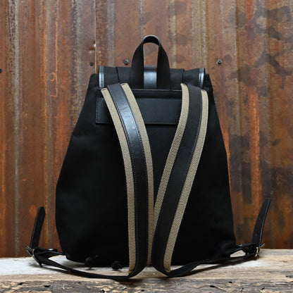 View of Filson Rugged Twill Drawstring Backpack in Black featuring leather straps and a rain flap