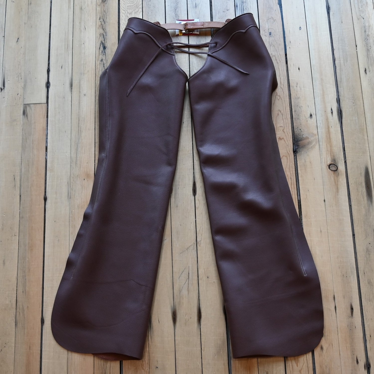 View of Weaver Shotgun Full Grain Chaps in brown oil-tanned leather with adjustable closures