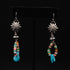 Peyote Bird Revival mixed stone and turquoise dangle earrings displayed on black background