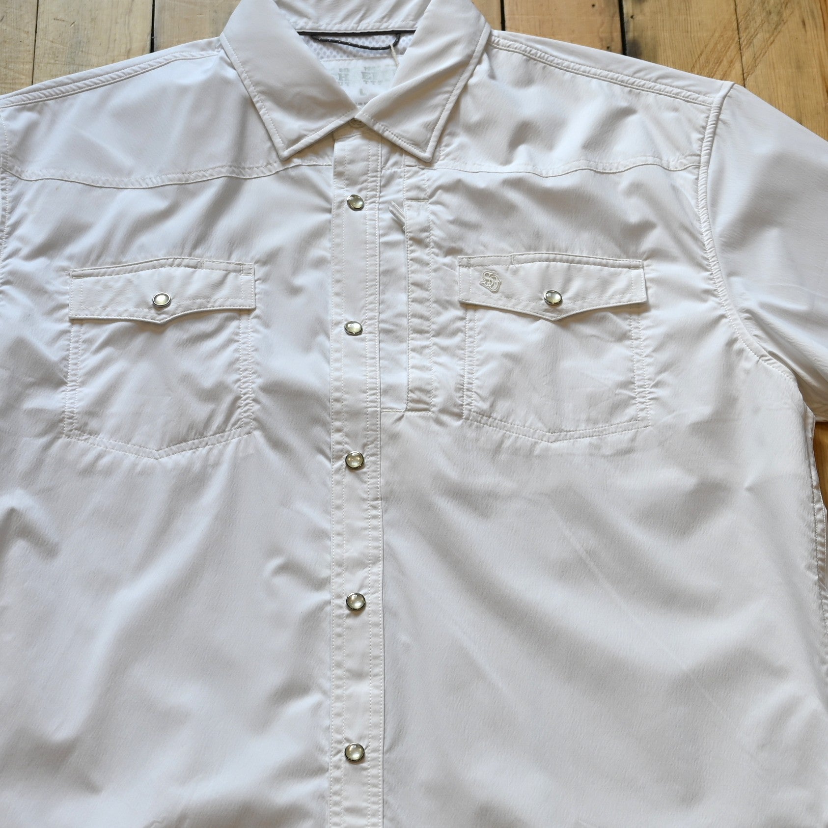 View of White short sleeve RangeTek Western snap shirt with mesh ventilation and security pocket