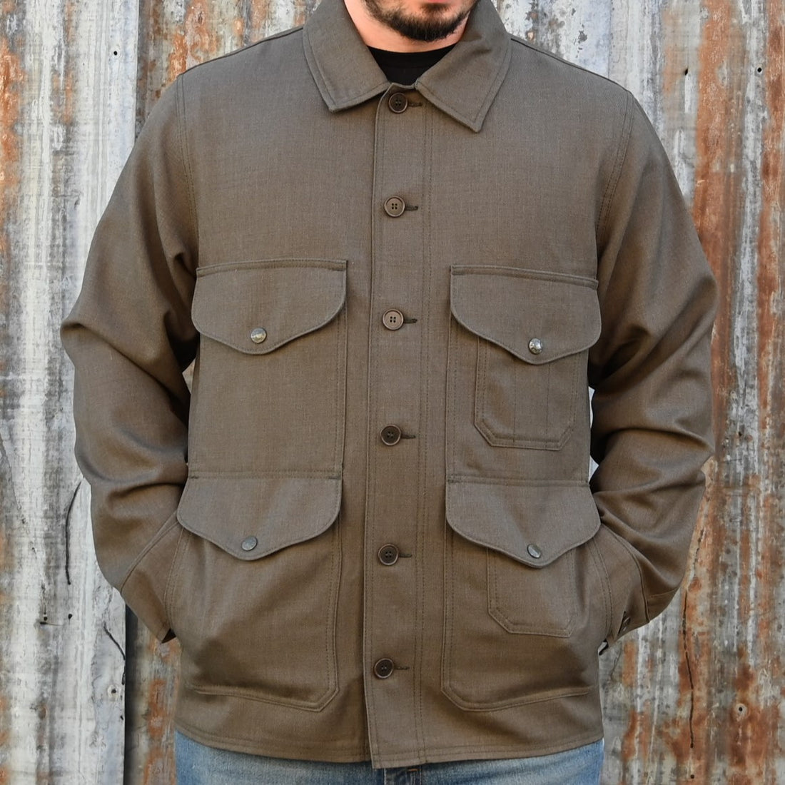 View of Filson Forestry Cloth Cruiser Jacket featuring four front cargo pockets and snap-front closure