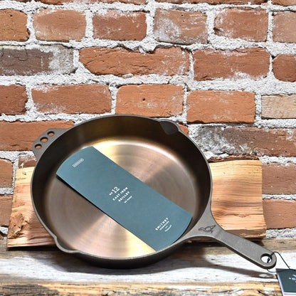 View of Smithey Ironware No. 12 Cast Iron Skillet with polished surface and ergonomic handle