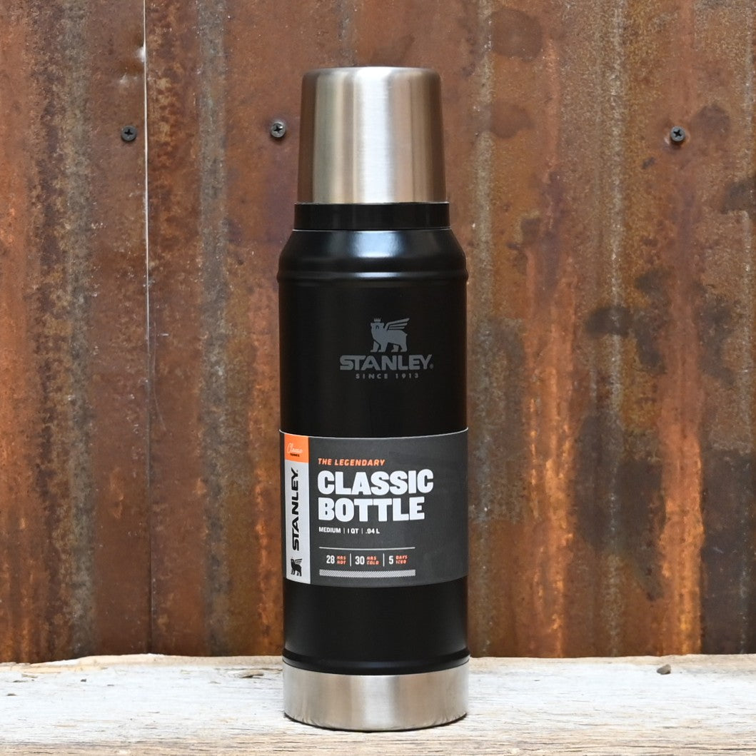 Stanley Classic Vacuum Bottle in matte black with twist-and-pour stopper, carry handle