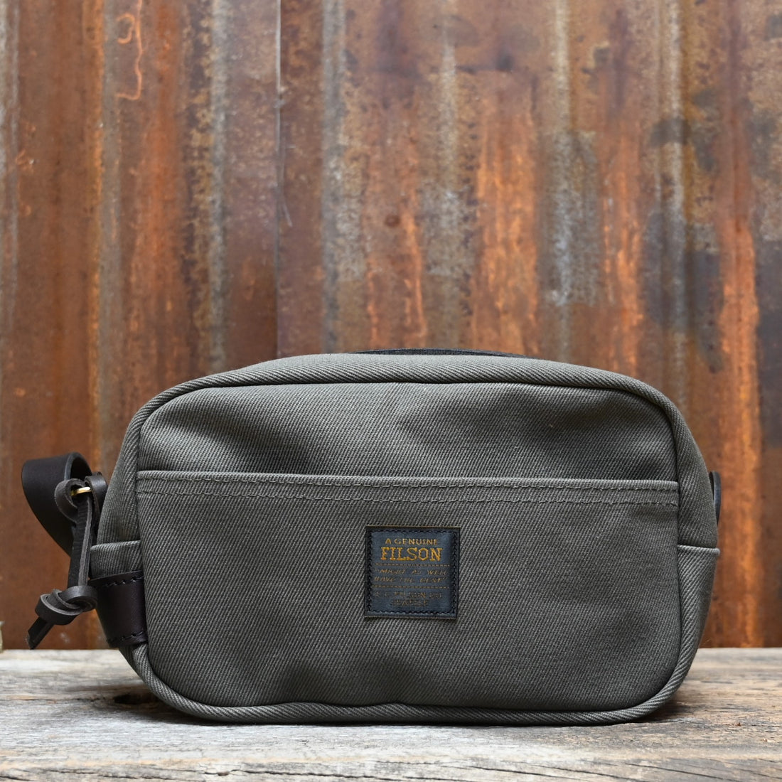 View of Filson Lightweight Travel Kit with Leather Loop in Otter Green featuring Bridle Leather accents and waterproof nylon lining