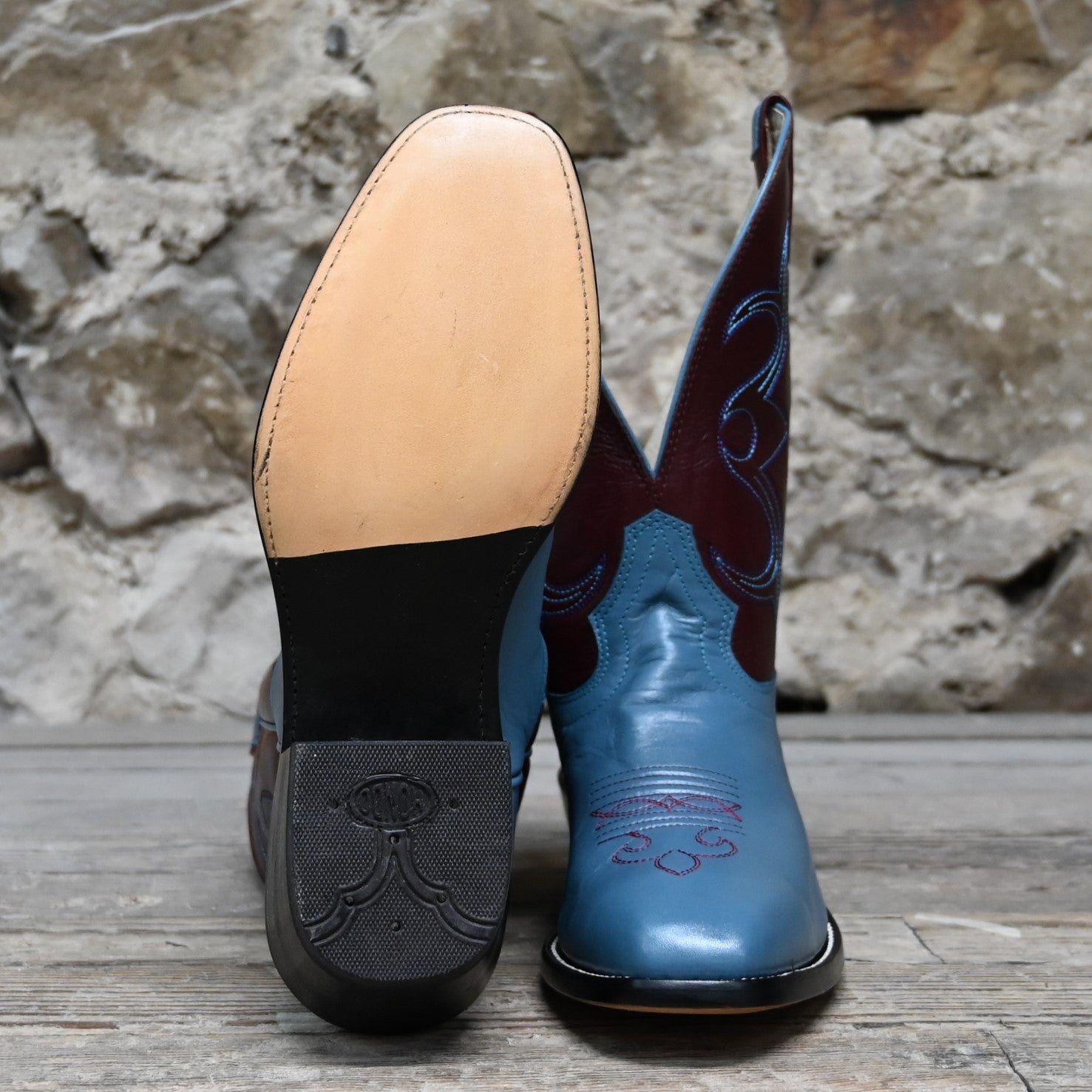 View of Atomic 79 exclusive Hondo Bronc Boot with burgundy top, sky blue vamp, French square toe, and spur lip
