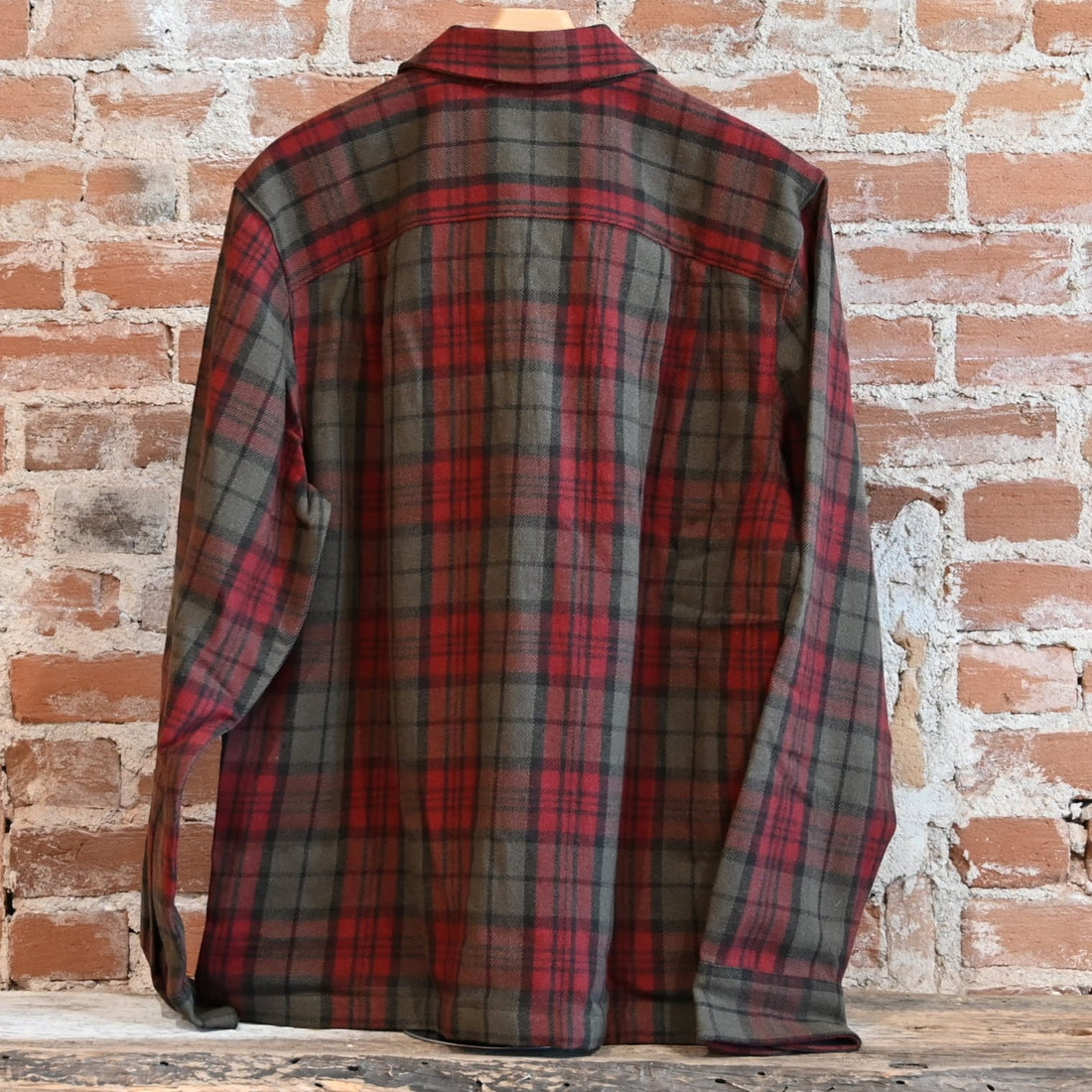 View of Filson Buckner Wool Camp Shirt in Olive Red Multi Plaid featuring unstructured camp collar and button-flap chest pockets