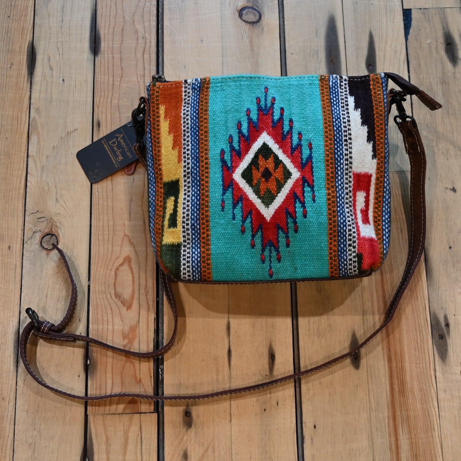 American Darling leather and saddle blanket crossbody bag in teal, red, orange, and brown with leather strap and conceal carry compartment