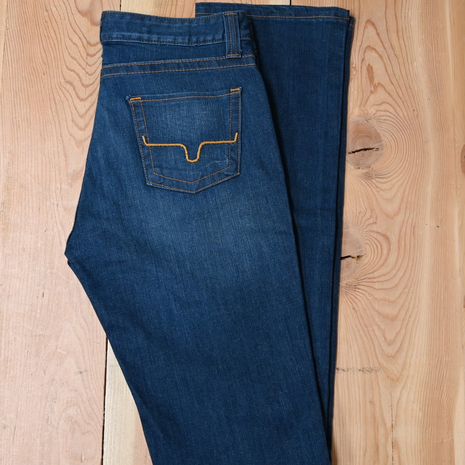 View of Kimes Ranch Betty17 Jeans in Blue, featuring embroidered horns on back pockets and a modest bootcut leg
