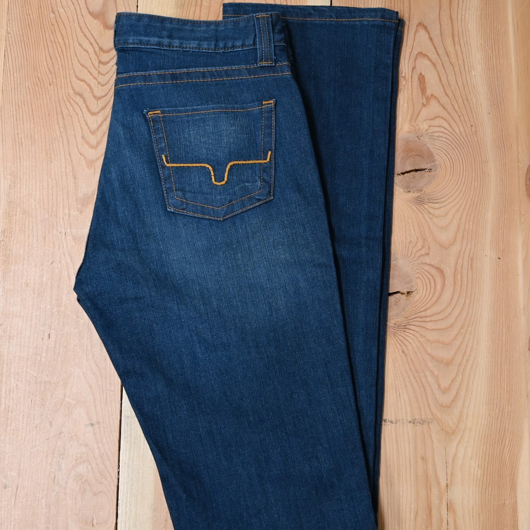 View of Kimes Ranch Betty17 Jeans in Blue, featuring embroidered horns on back pockets and a modest bootcut leg