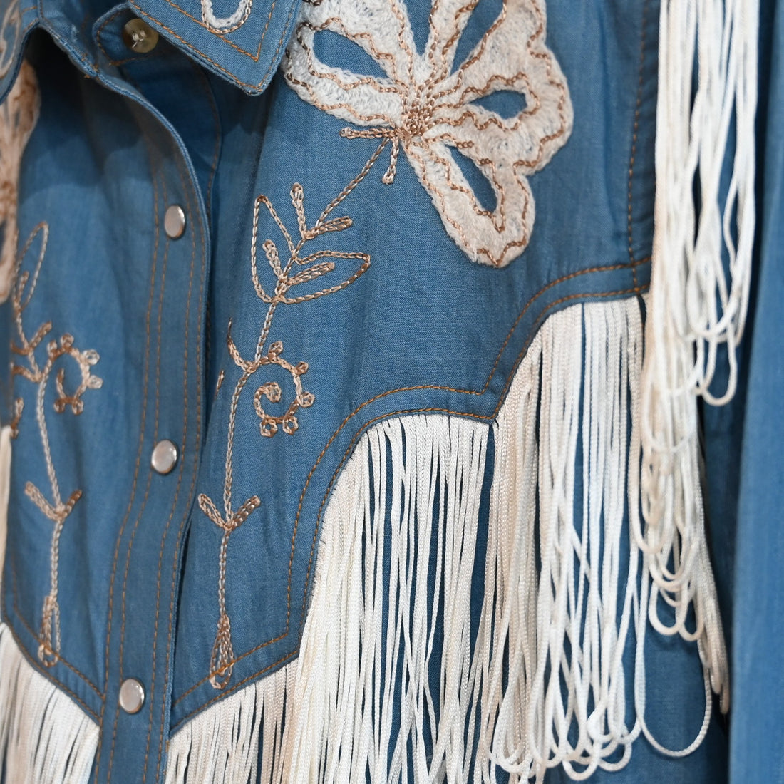View of Rockmount ladies denim Western dress with fringe and floral embroidery